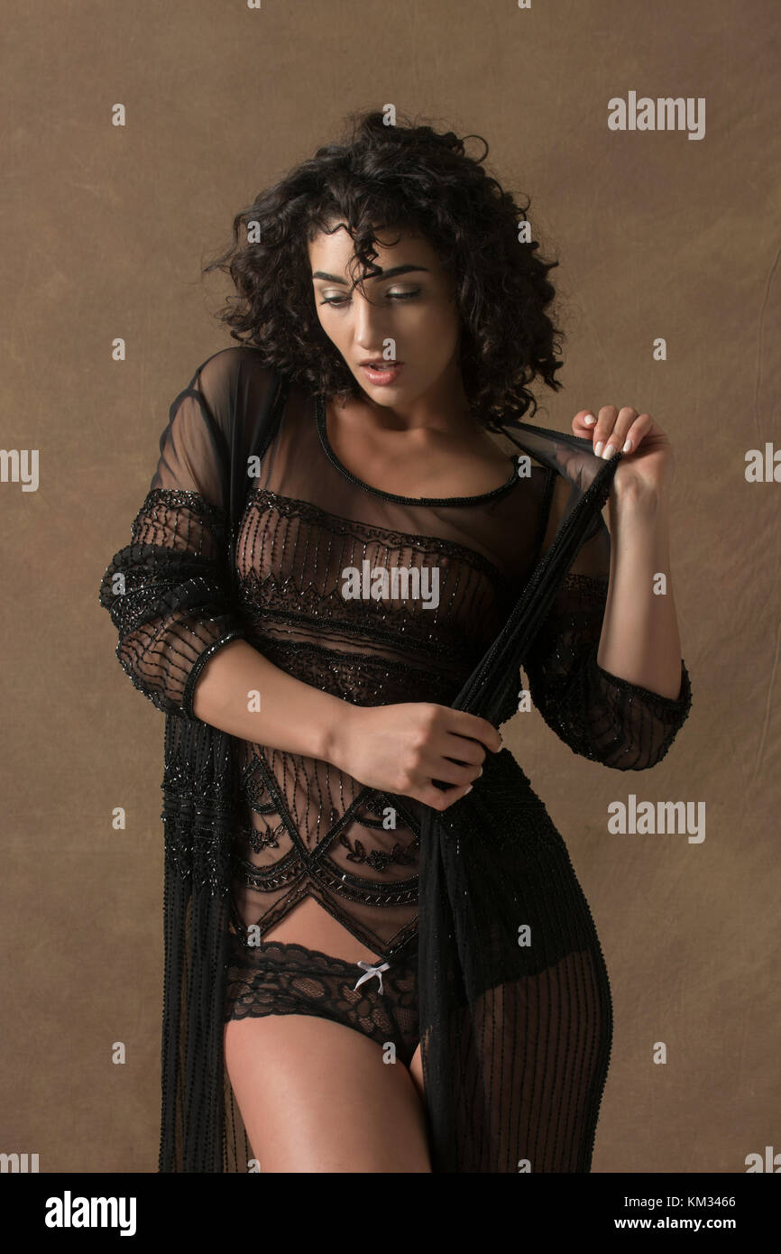 sexy bedroom clothes for women Sensual young woman wearing sheer lingerie Stock Photo
