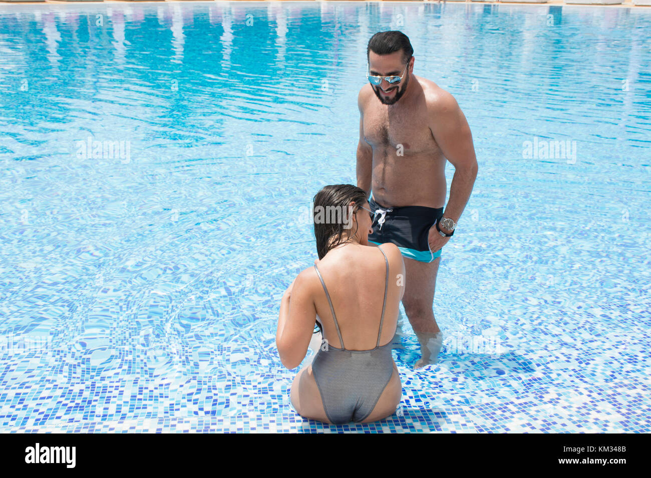 Happy couple enjoying the swimming pool in the summer Stock Photo