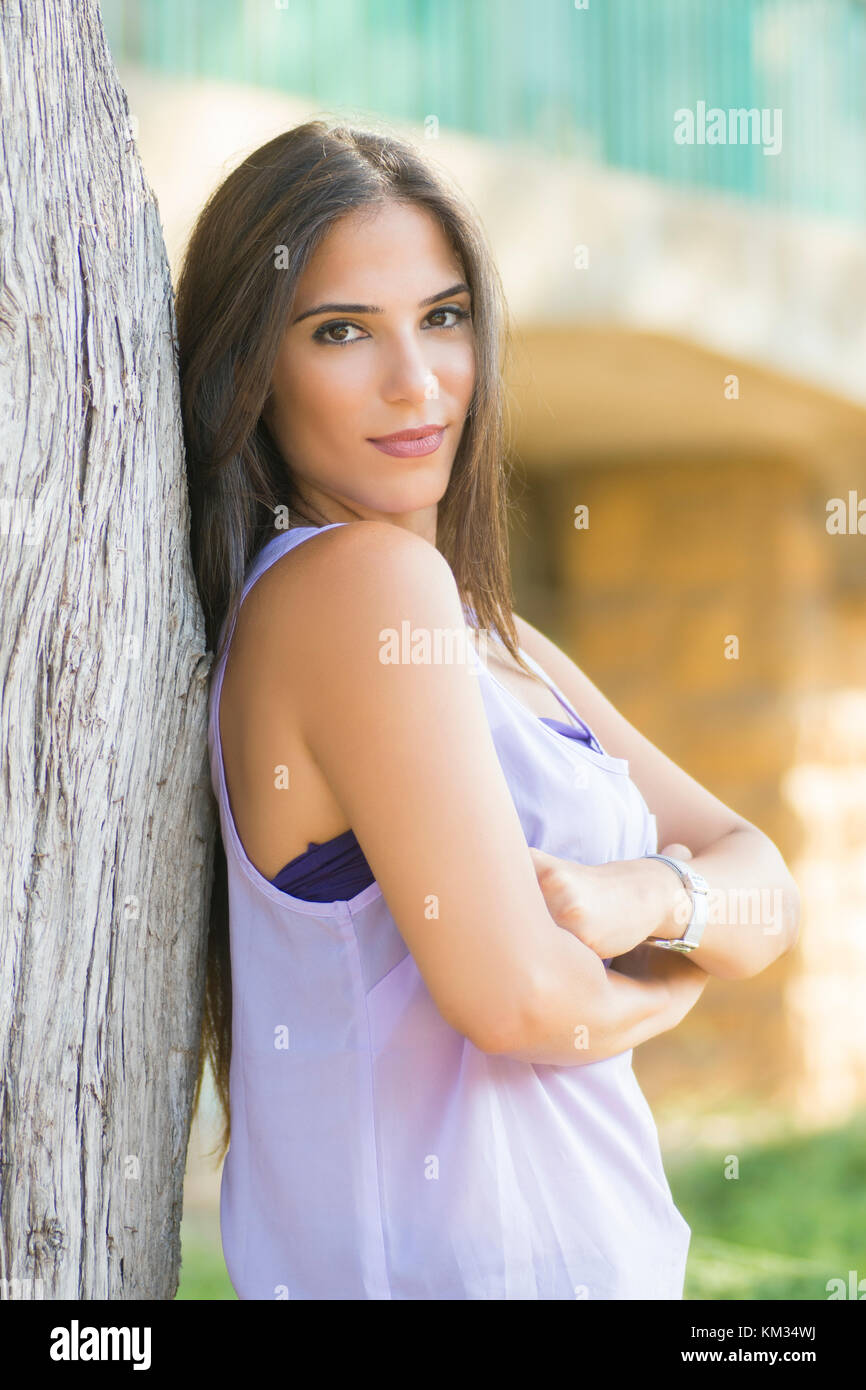 Beautiful young woman smiling outdoors Stock Photo - Alamy