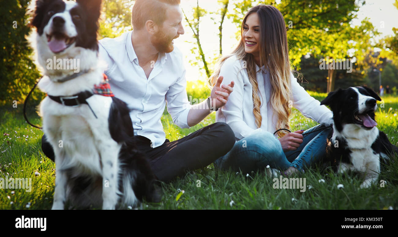 Beautiful couple walking dogs and bonding in nature Stock Photo - Alamy