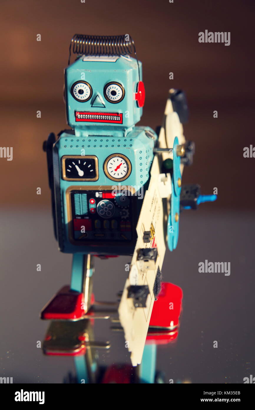 Computer Robot Toy Tin toy robot carries computer circuit board, artificial intelligence ...