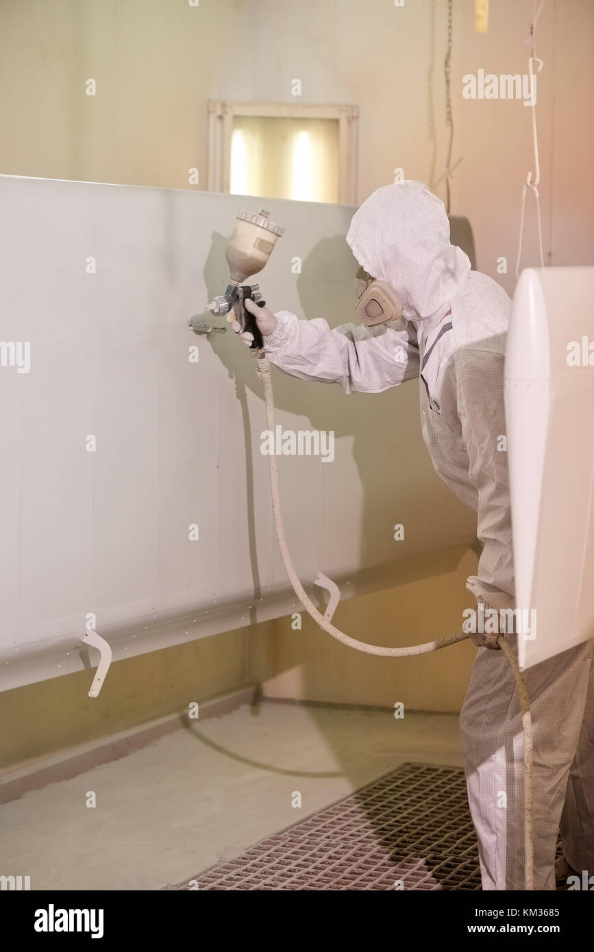 Worker spray painting airplane wing Stock Photo Alamy
