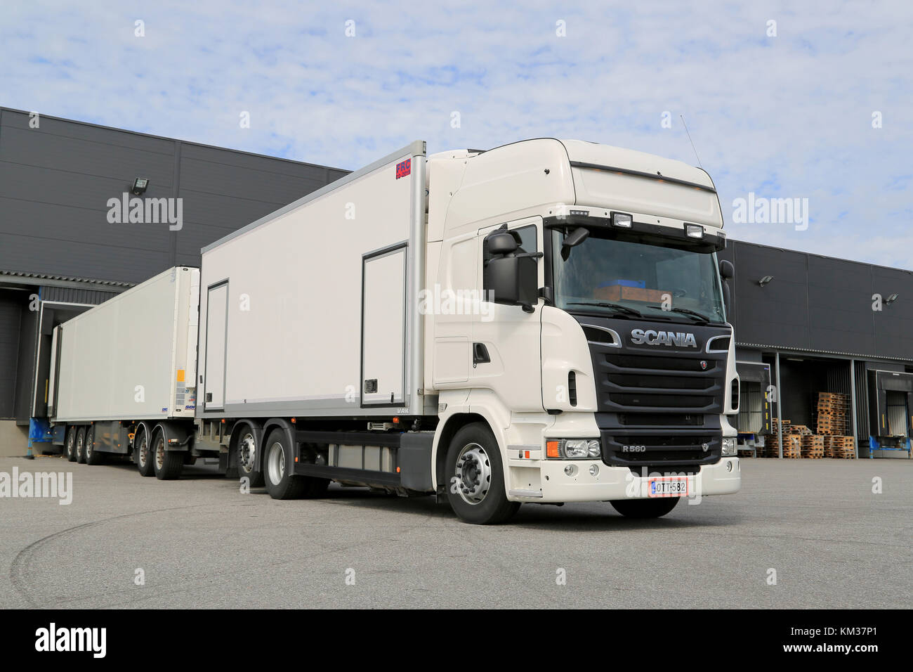 TURKU, FINLAND – APRIL 26, 2014: White Scania R560 V8 truck unloading by a warehouse. According to Statistics Finland, A total of 71 million tonnes of Stock Photo