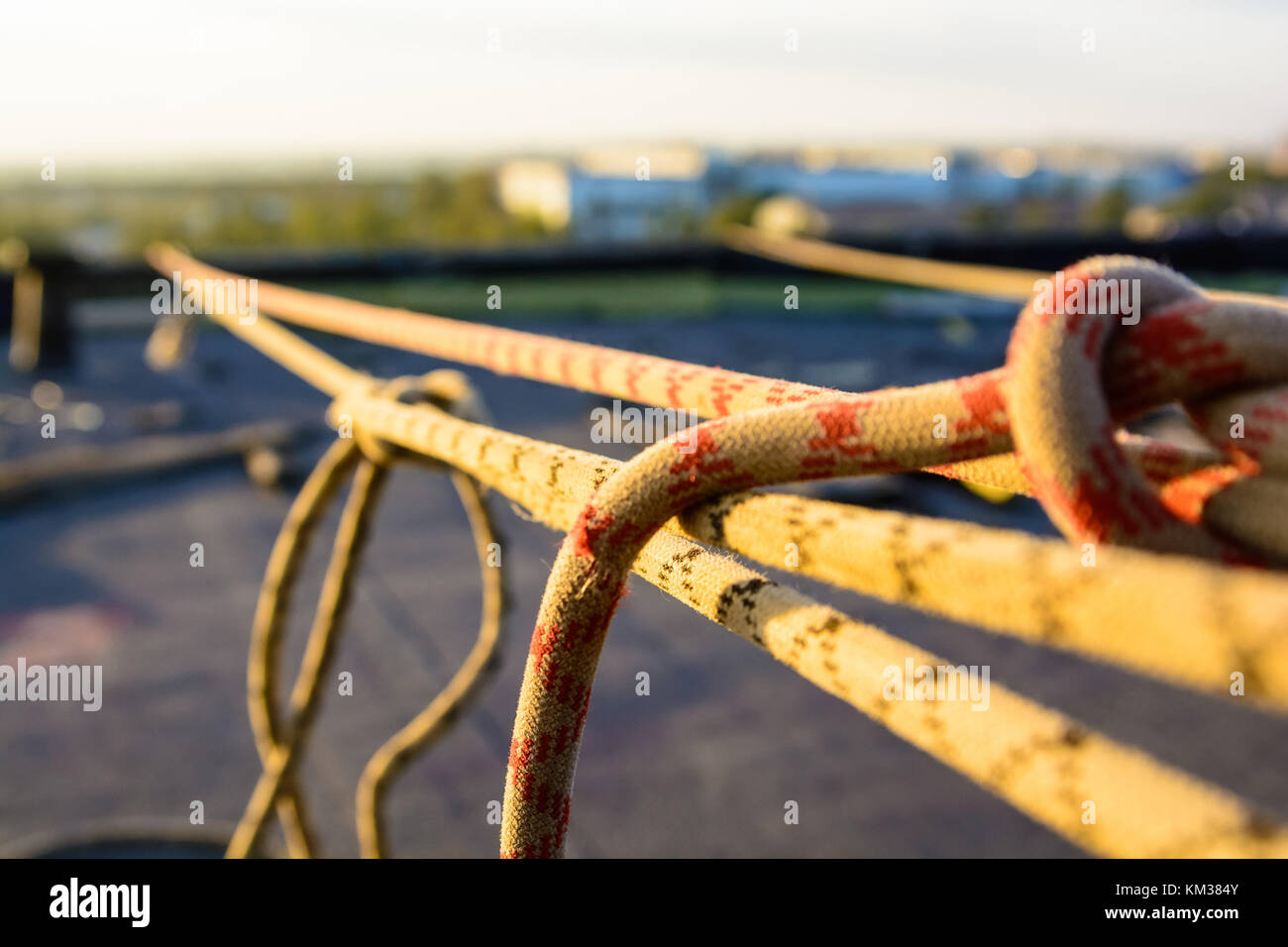 Closeup stretched and tied industrial braided rope Stock Photo - Alamy