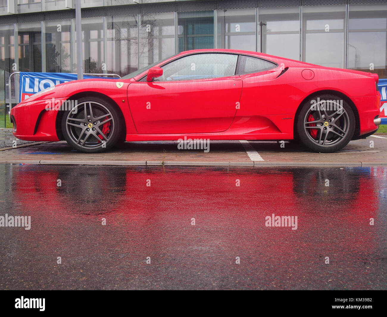 VILNIUS, LITHUANIA-AUGUST 20, 2017: Red Ferrari F430 in the rain. This model is one of the most popular cars for Ferrari fans. Stock Photo