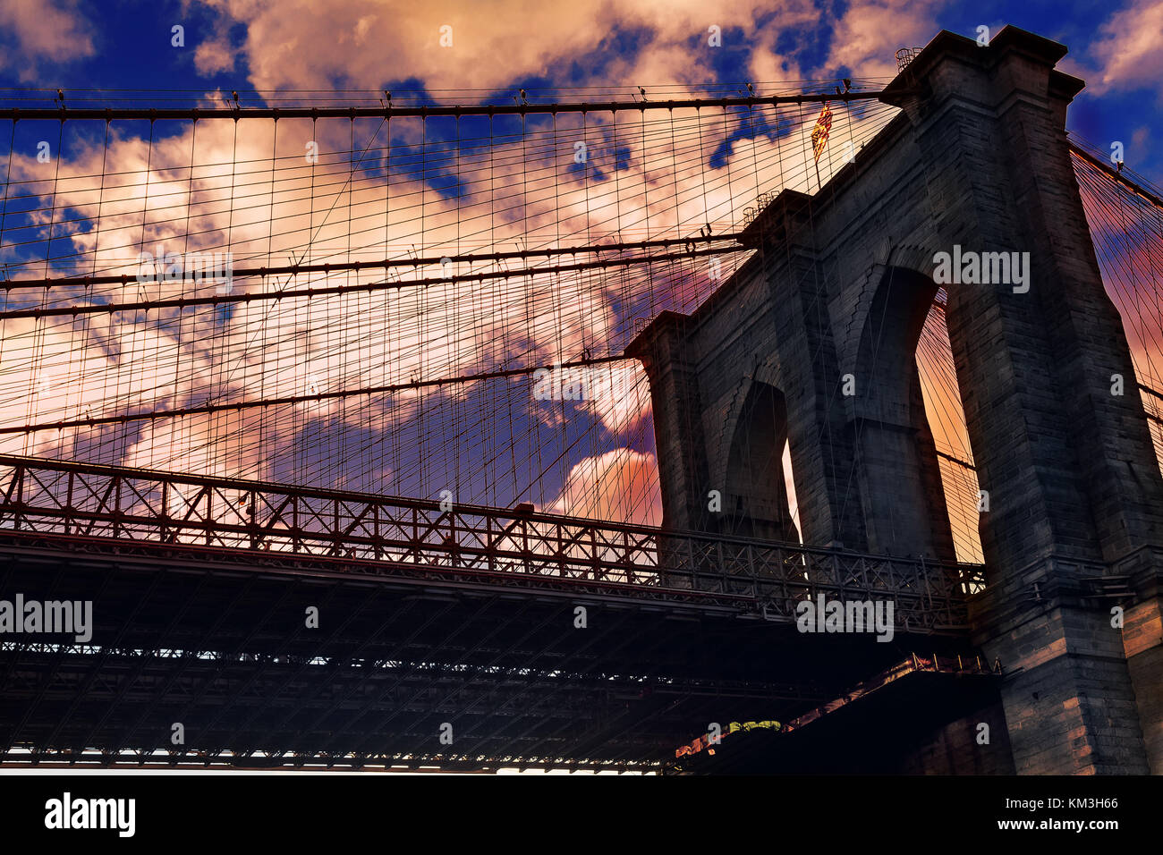Brooklyn Bridge over East River viewed from New York City Lower Manhattan waterfront at sunset. Stock Photo