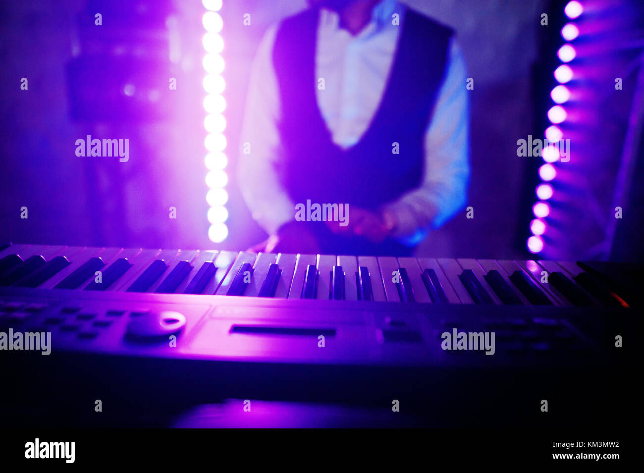 Hand of keyboardist on stage with lights Stock Photo Alamy