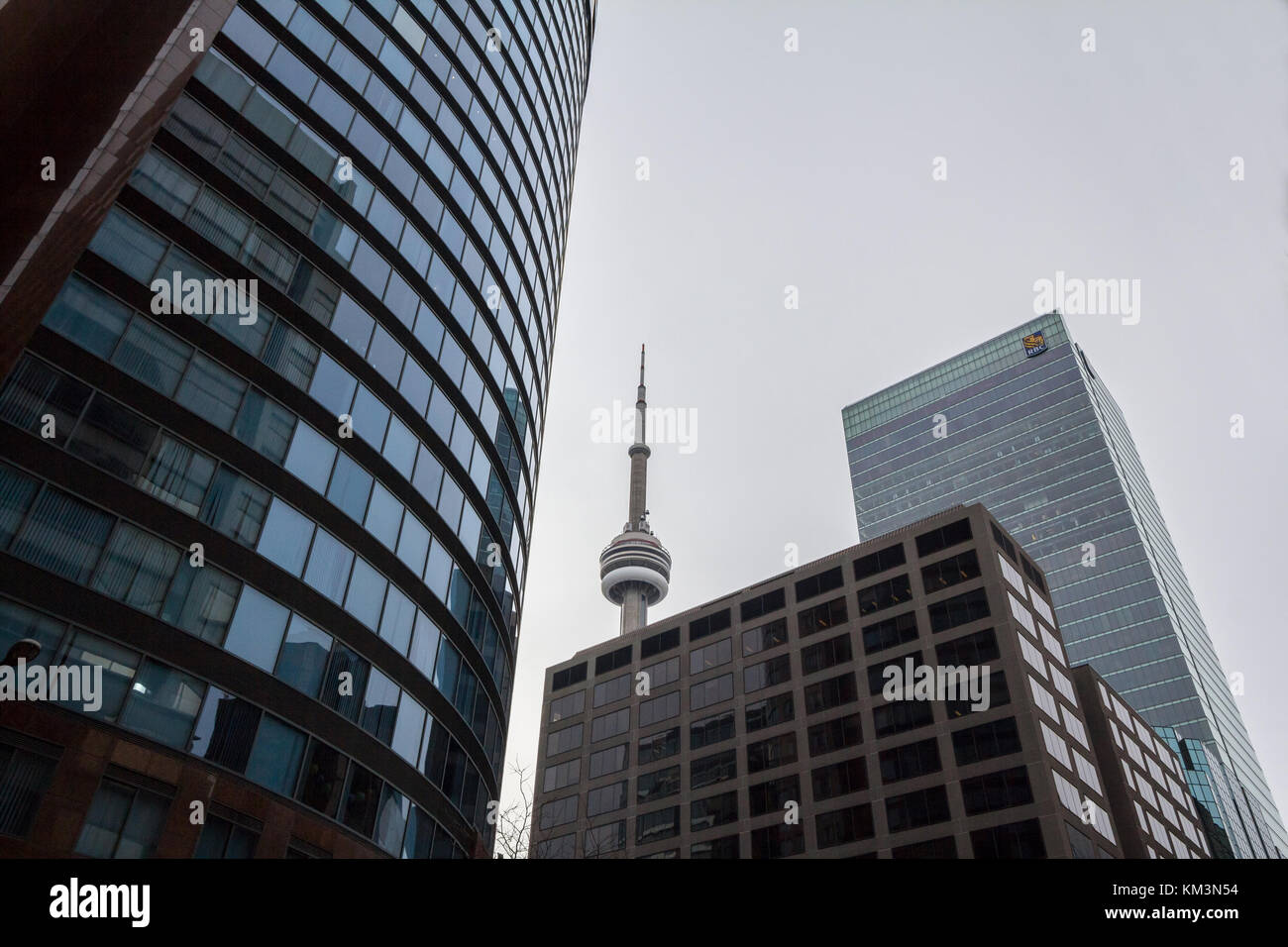 TORONTO, CANADA - DECEMBER 31, 2016: Canadian National Tower (CN Tower) surrounded by more modern buildings in downtown Toronto. CN Tower is the talle Stock Photo
