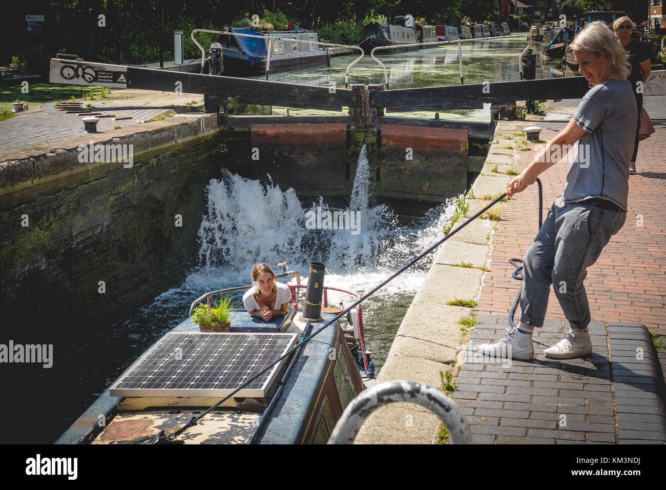Narrow boat in a lock along Regent's Canal in East London (UK). August 2017. Landscape format. Stock Photo