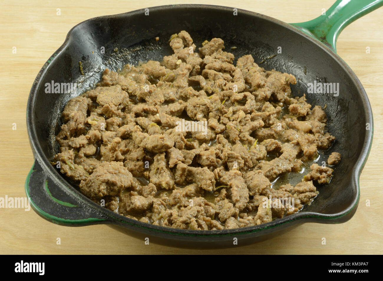 Stir fry strips of beef in cast iron frying pan skillet Stock Photo Alamy