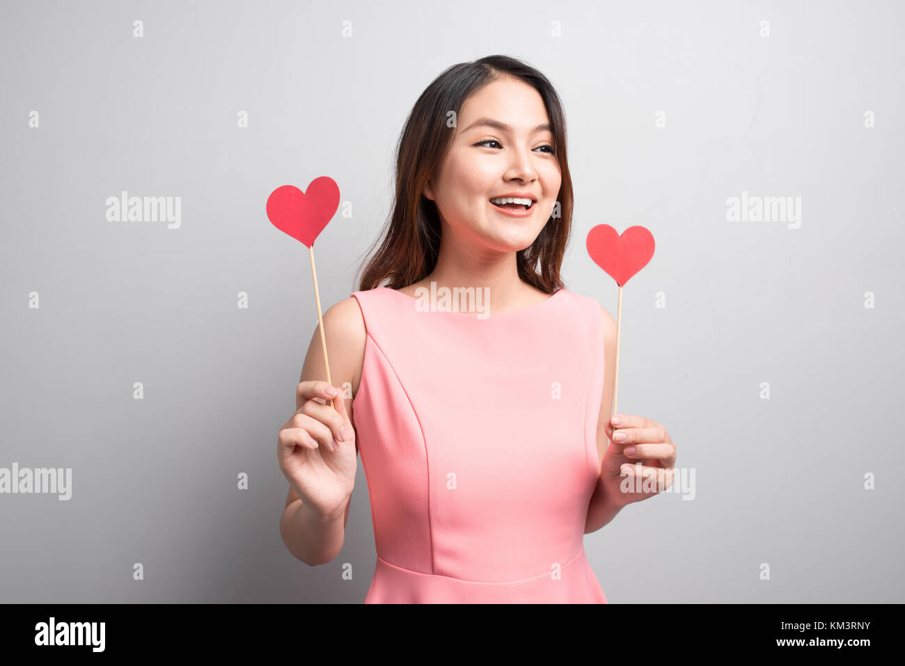 Charming asian woman holding red heart shape Stock Photo - Alamy