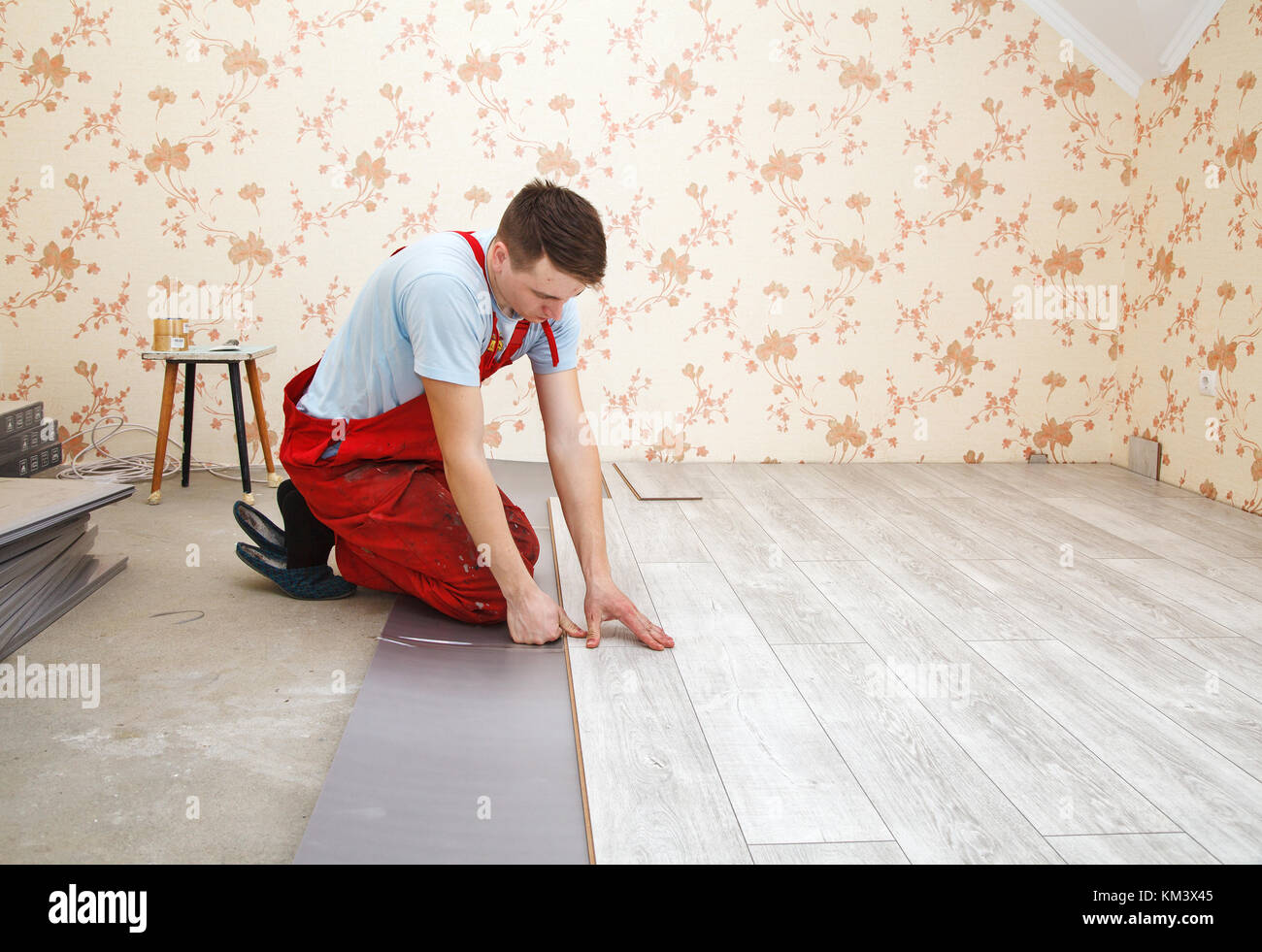 Handyman Laying Down Laminate Flooring Boards While Renovating A