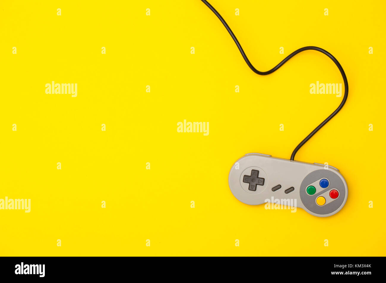 Retro computer gaming controller on a bright yellow background Stock ...