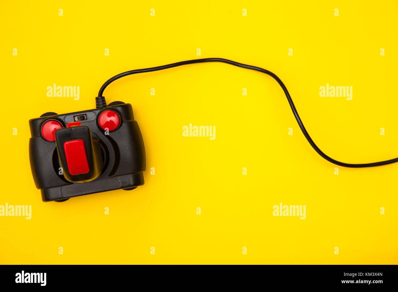 Retro computer gaming controller on a bright yellow background Stock Photo