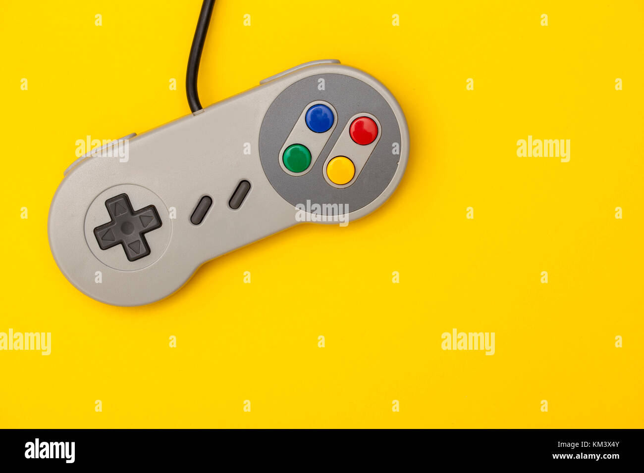 Retro computer gaming controller on a bright yellow background Stock ...