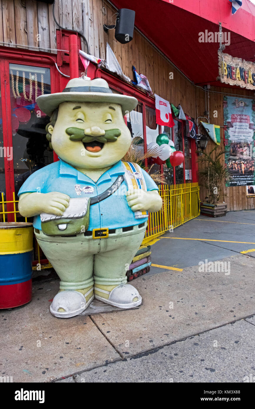A ceramic statue of a man that appears to be a Mexican tourist outside of a Mexican restaurant on Northern Blvd. in Long Island City Queens, New York. Stock Photo