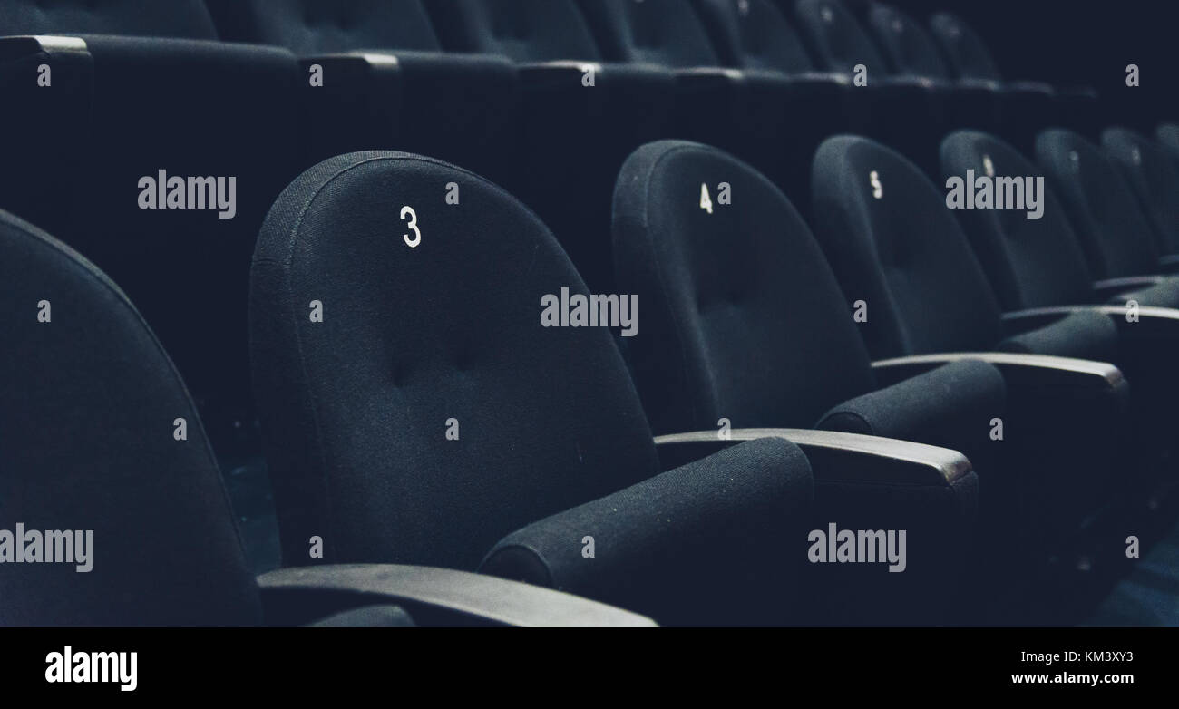 Inside of auditorium movie theatre with seats and numbers. Rows of