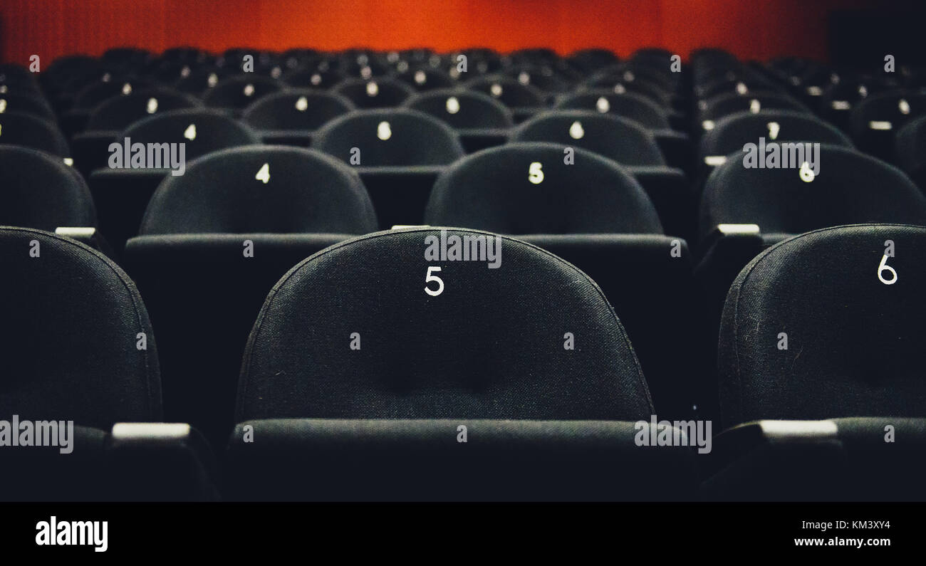 Inside of auditorium movie theatre with seats and numbers. Rows of