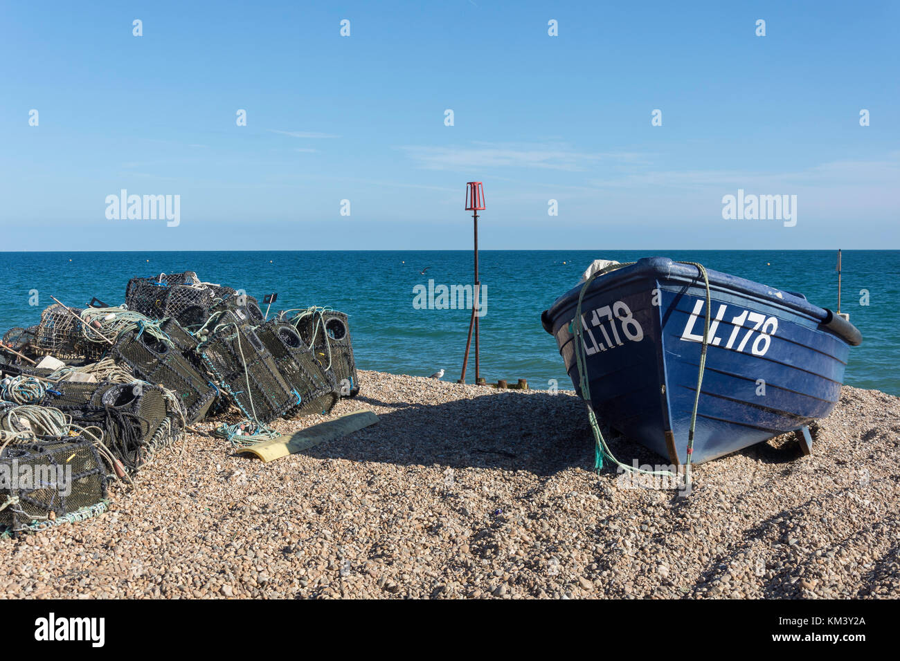 Fishing boat and lobster pots on beach, Bognor Regis, West Sussex, England, United Kingdom Stock Photo