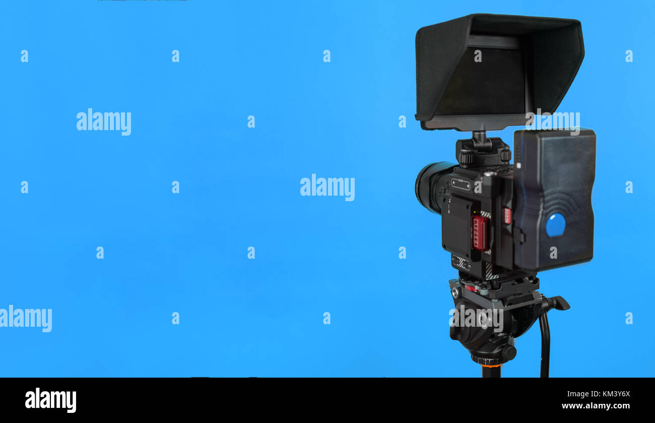 Professional video camera on vivid color background making contrast ...