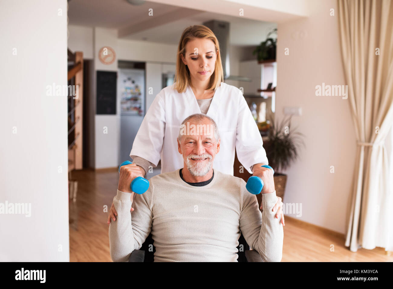 Nurse and senior man in wheelchair during home visit Stock Photo Alamy
