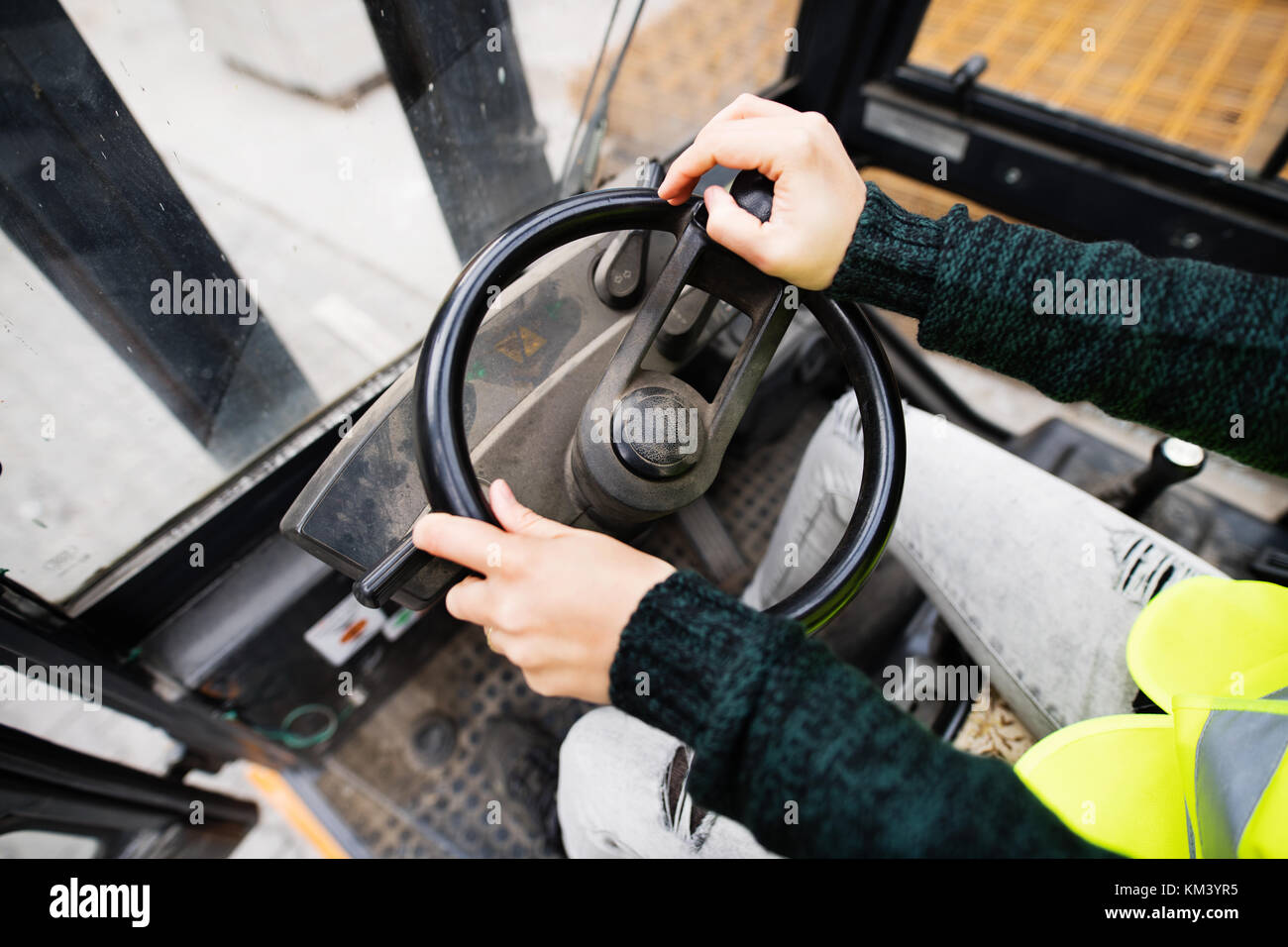 Woman forklift truck driver in an industrial area. Stock Photo