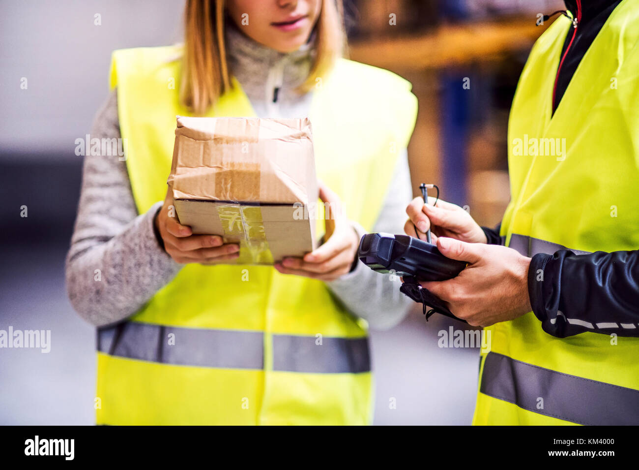 Young warehouse workers working together Stock Photo - Alamy