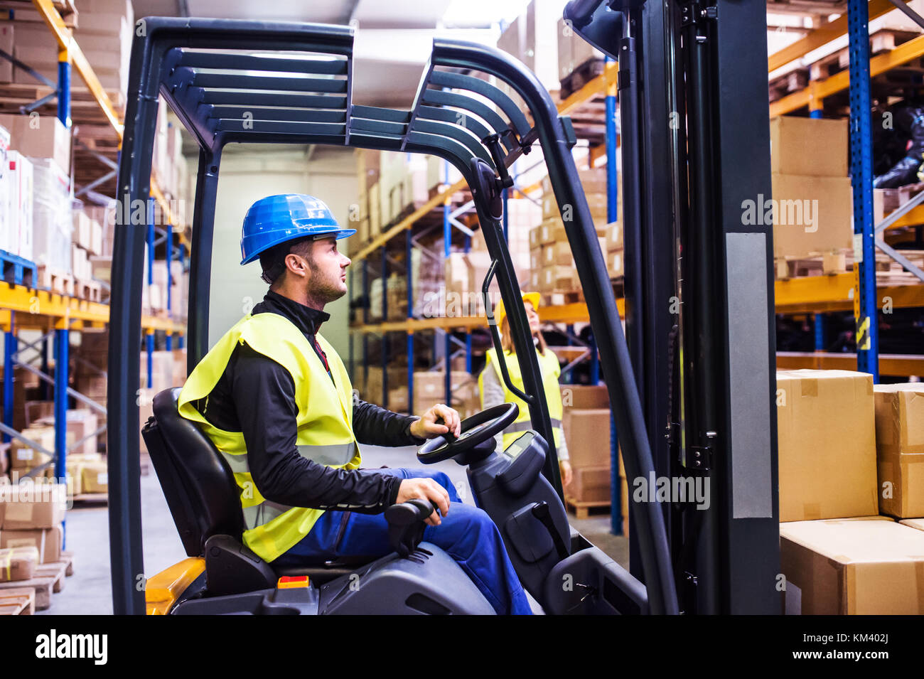 Young warehouse workers working together Stock Photo - Alamy
