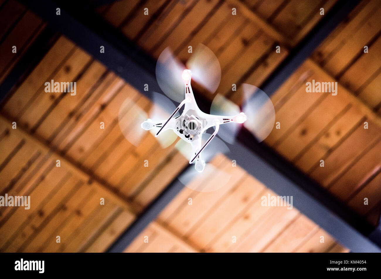 White drone flying inside the building. Stock Photo