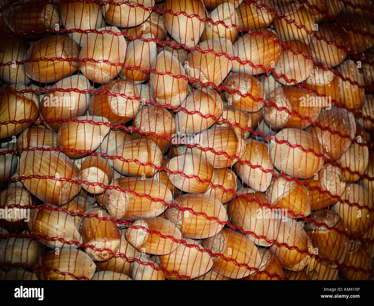 Detail of a net sack full of hazelnuts. Stock Photo