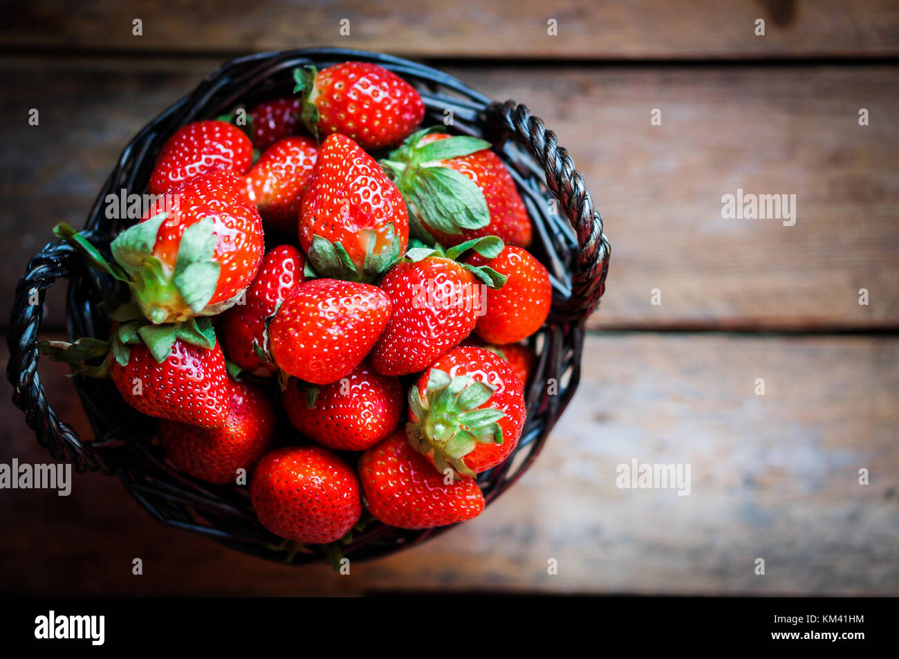 Basket Of Fresh Strawberries On Wooden Background Stock Photo - Alamy
