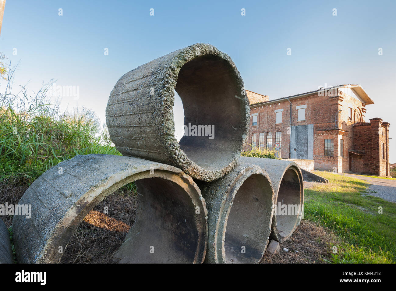 Old concrete tubes. Pipes for drainage. Hoses for construction industry. Stock Photo