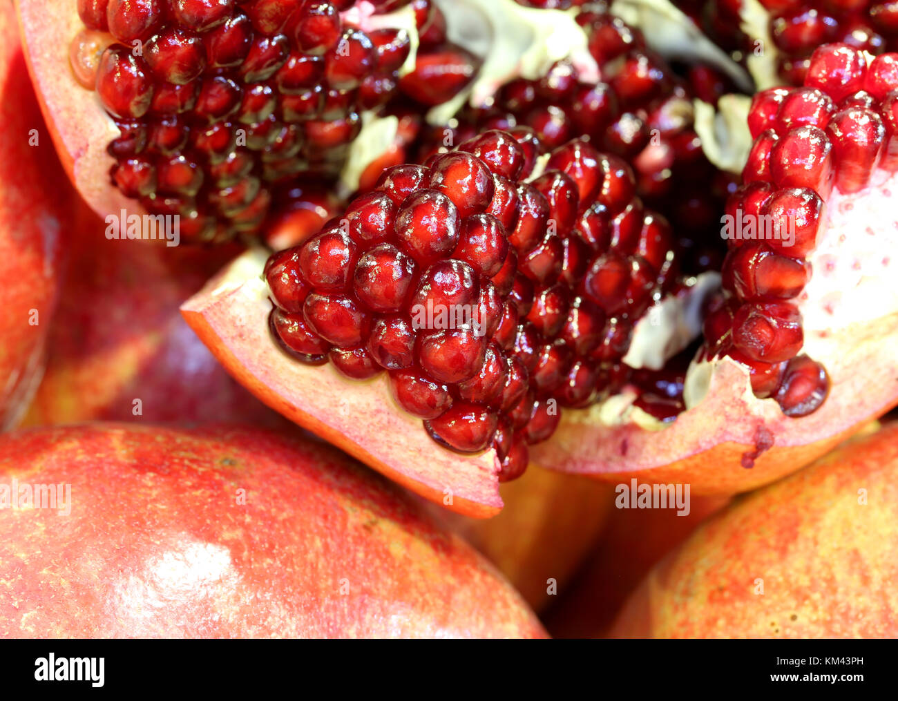 background of many pomegranate fruits with red seeds inside the typical autumn fruit Stock Photo Alamy
