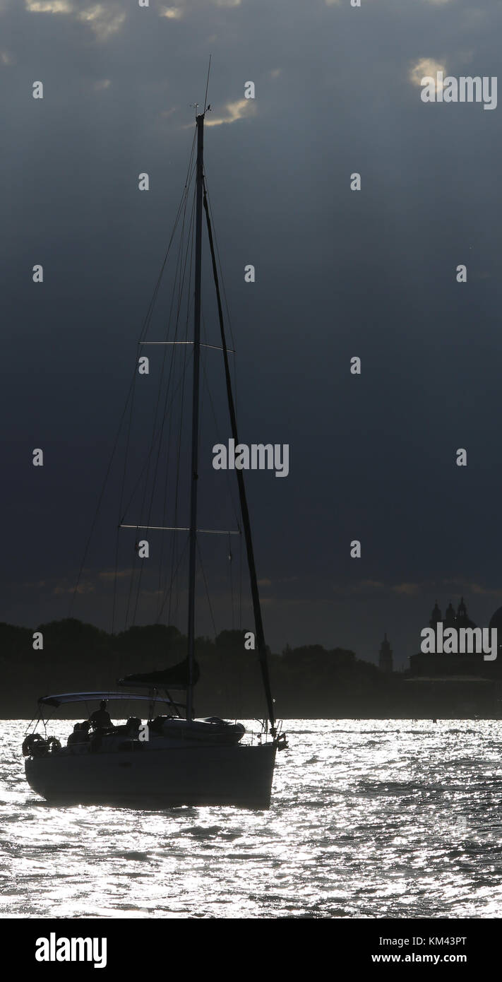 boat sailing on the sea with backlit photographic effect Stock Photo ...