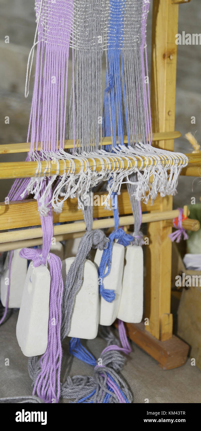 ancient wooden frame to weave the threads and create a fabric, The ...