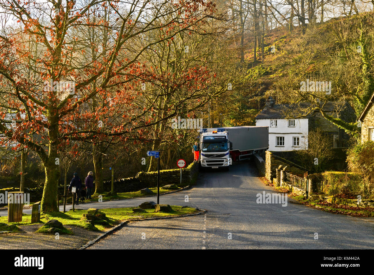 A very large lorry in a tight spot on a small bridge in the Lake District Stock Photo