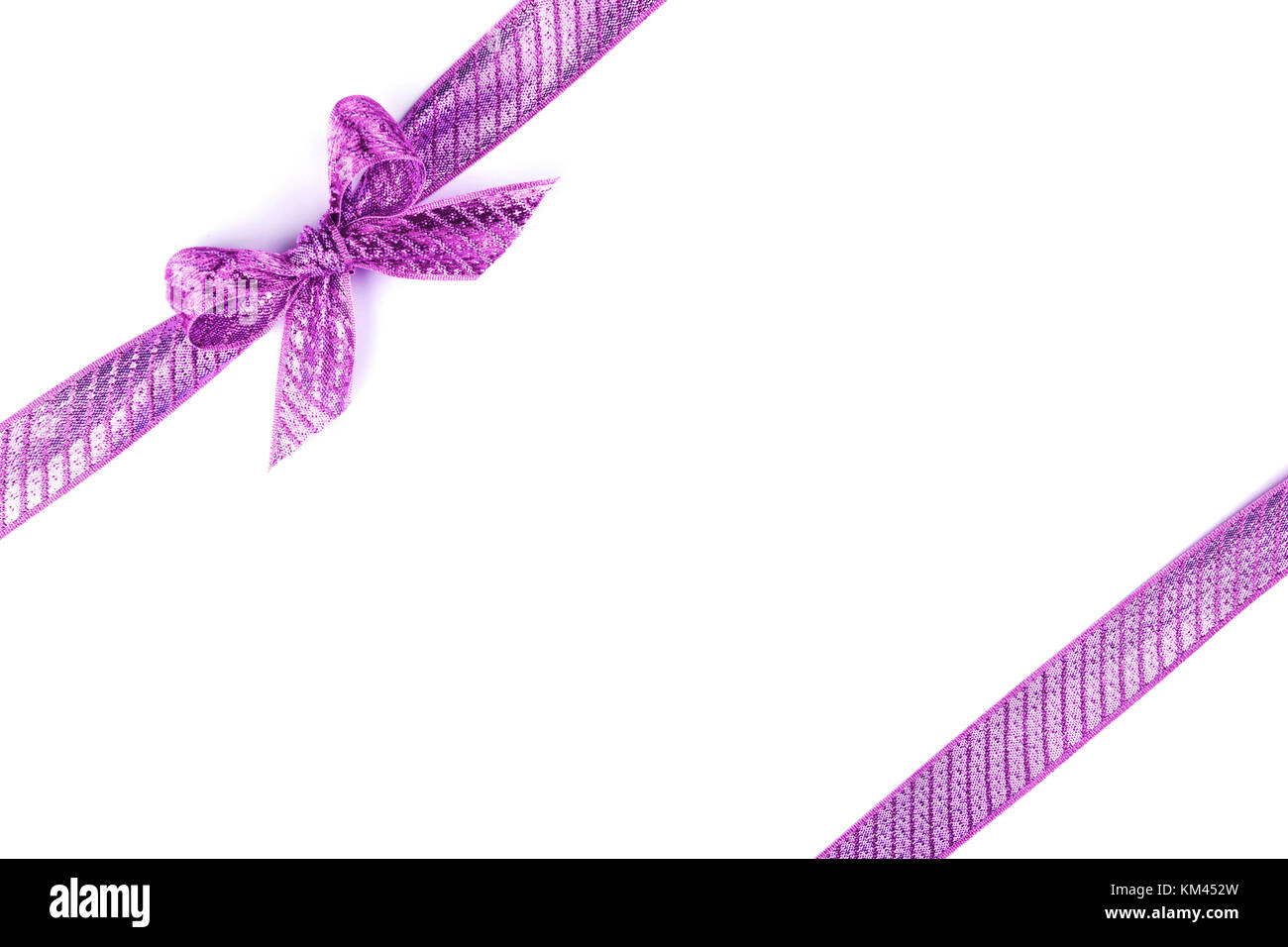 Purple bow tied using silk ribbon Stock Photo