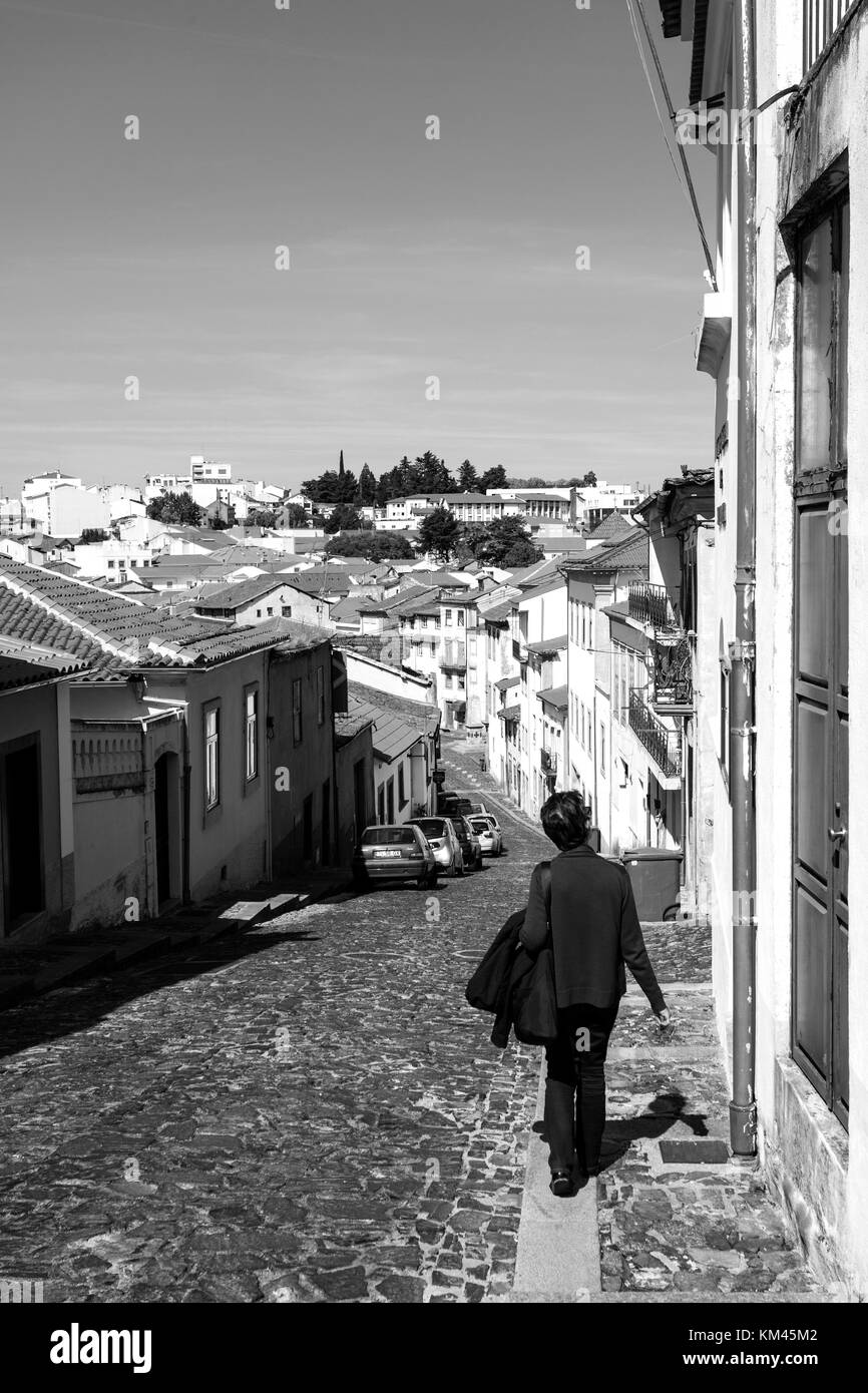 Tourist strolling along the cobbled streets of the historic old city of Braganca, Portugal Stock Photo