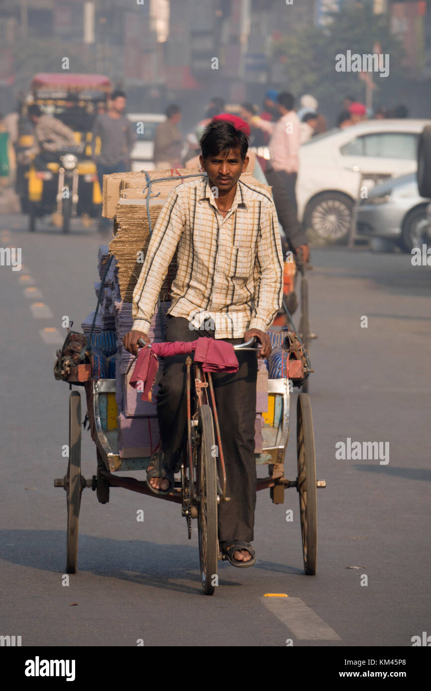 Indian man pedaling cycle rickshaw in Amritsar, Punjab Stock Photo