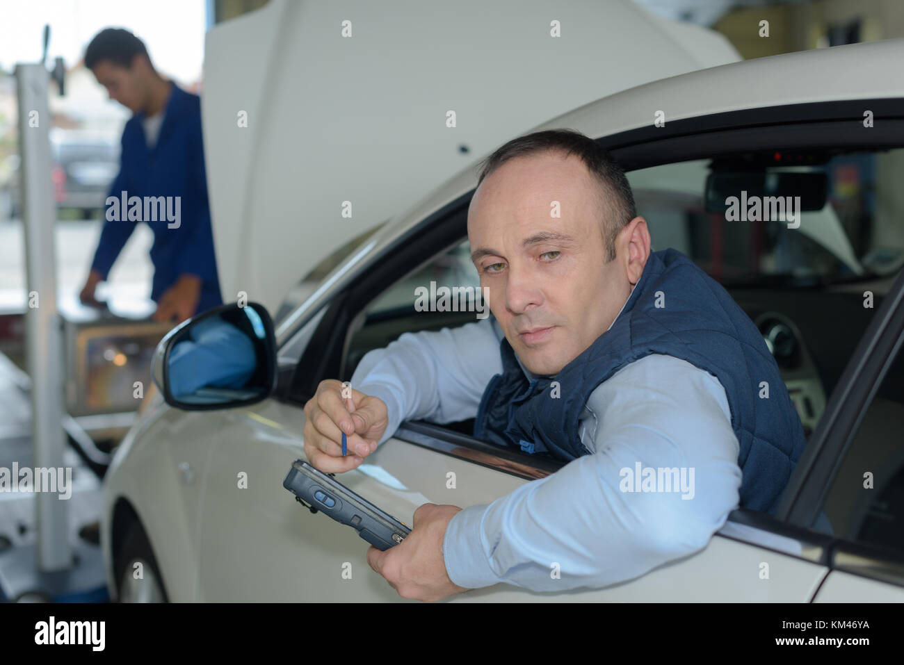 mechanics trying to find car problem Stock Photo - Alamy