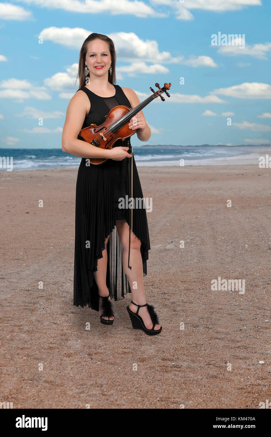 Beautiful young woman playing a violin classical instrument Stock Photo ...
