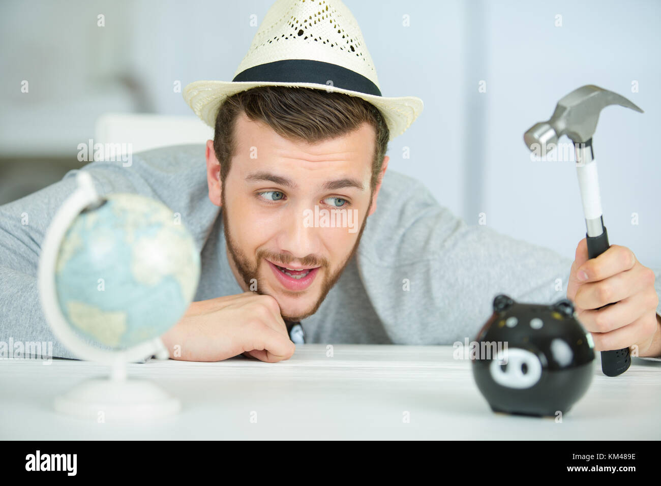 man with a hammer going to break the piggy bank Stock Photo - Alamy