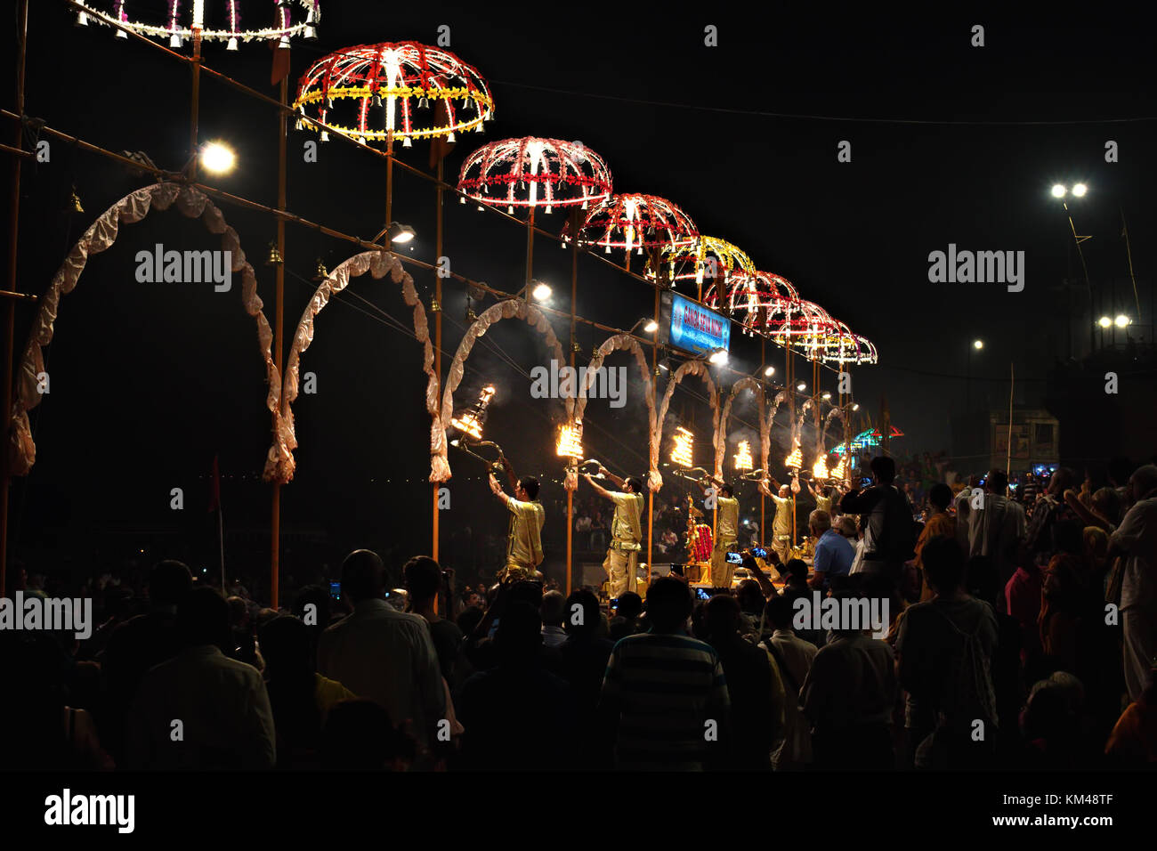 people watching a group of young priests performing aarti at Dashashwamedh Ghat by the river Ganges, Banaras, Varanasi, Kashi, India Stock Photo