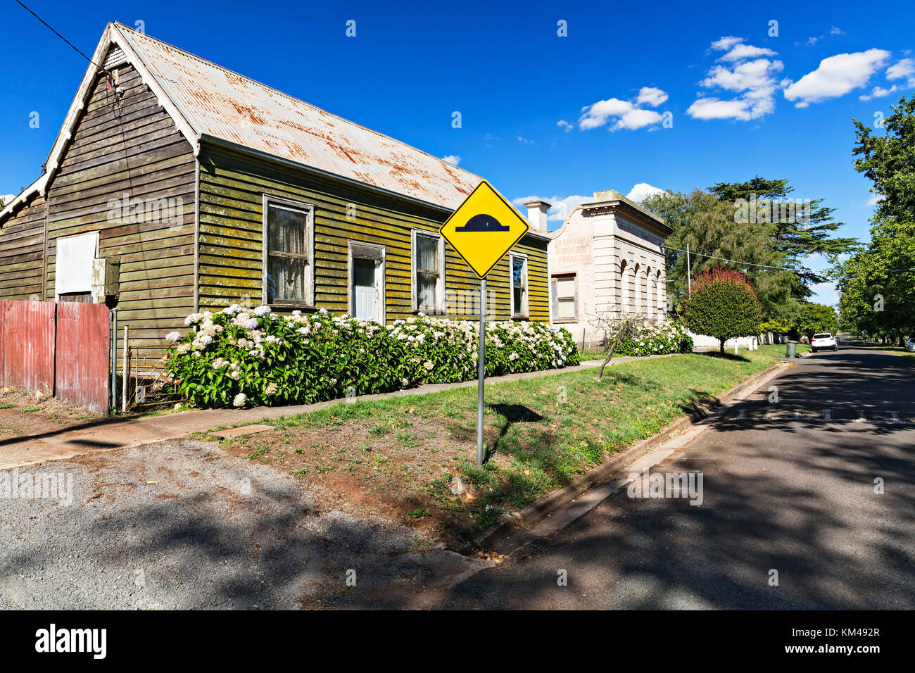 An old weatherboard house alongside the circa 1866 National Australia Bank building in Learmonth Victoria Australia.The bank served the community from Stock Photo