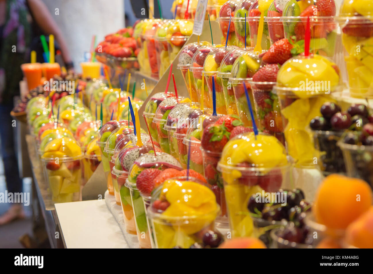 Fresh fruit salads stand in fruit store at La Boqueria market, a famous covered market in the City. Stock Photo