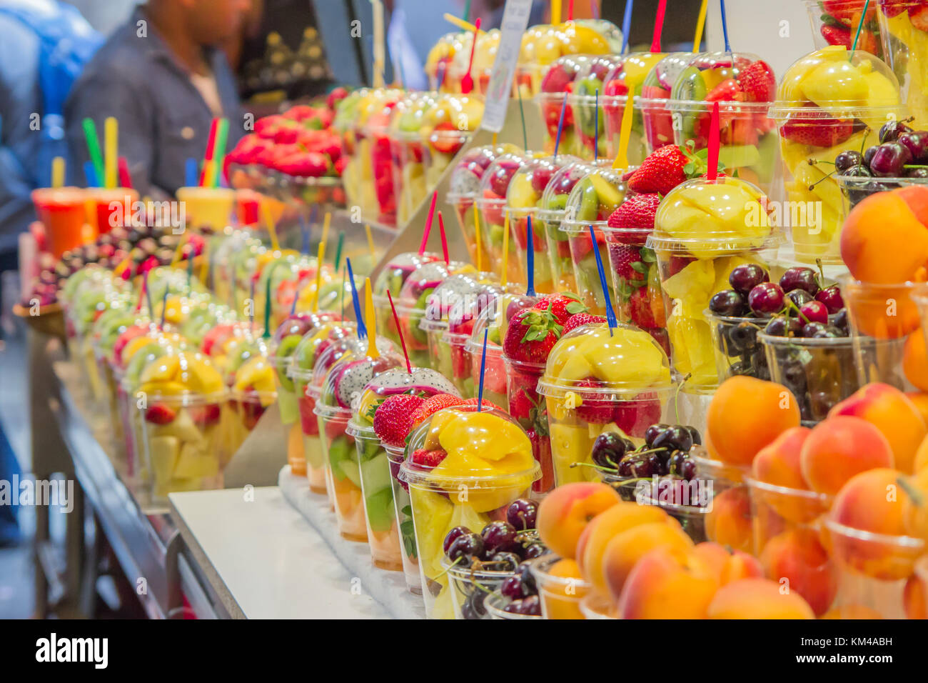 Fresh fruit salads stand in fruit store at La Boqueria market, a famous covered market in the City. Stock Photo