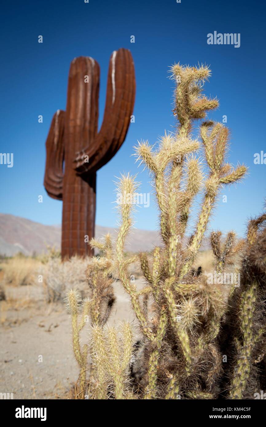Sculpture of a cactus next to the real thing, from the "Sky Art