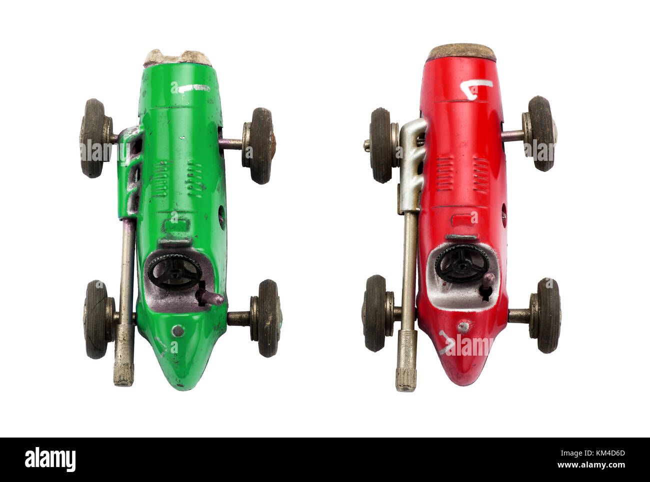 Two retro racing cars toys of green and red colors with open cockpit and big exhaust pipes. Isolated on white background and viewed from above Stock Photo