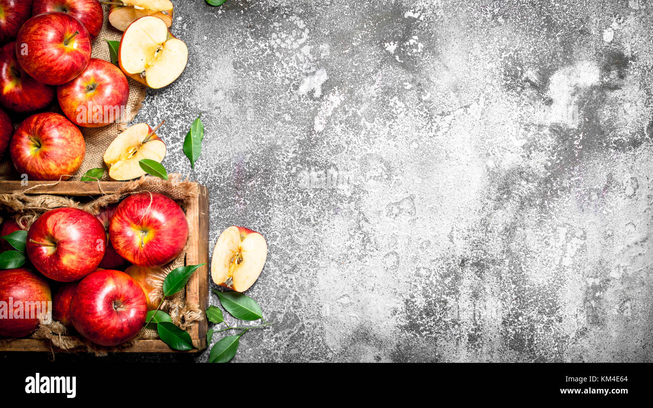 Red apples in an old box. On rustic background Stock Photo - Alamy