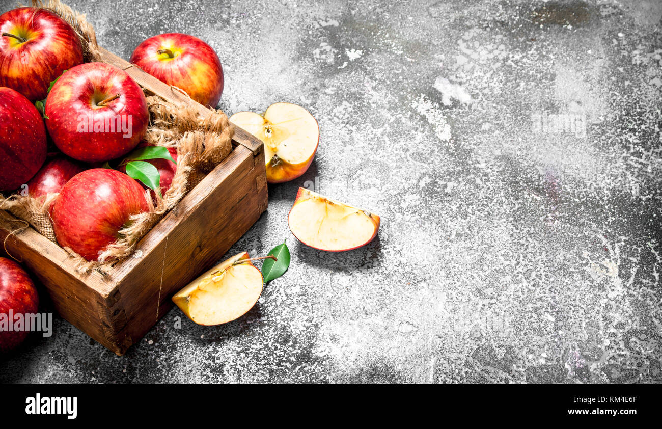 Red apples in an old box. On rustic background Stock Photo - Alamy